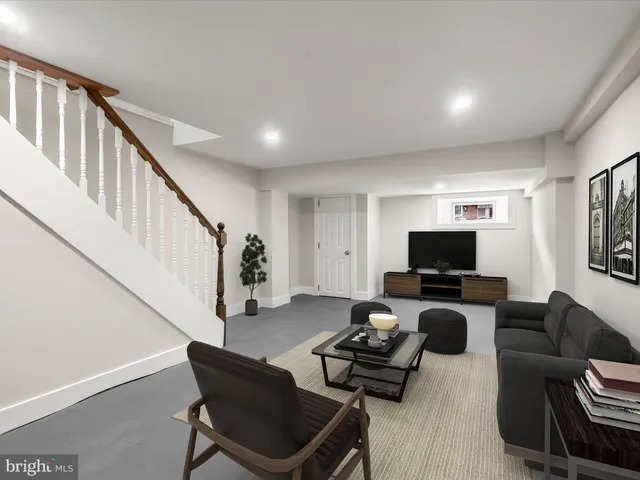 a living room with furniture a flat screen tv and a window
