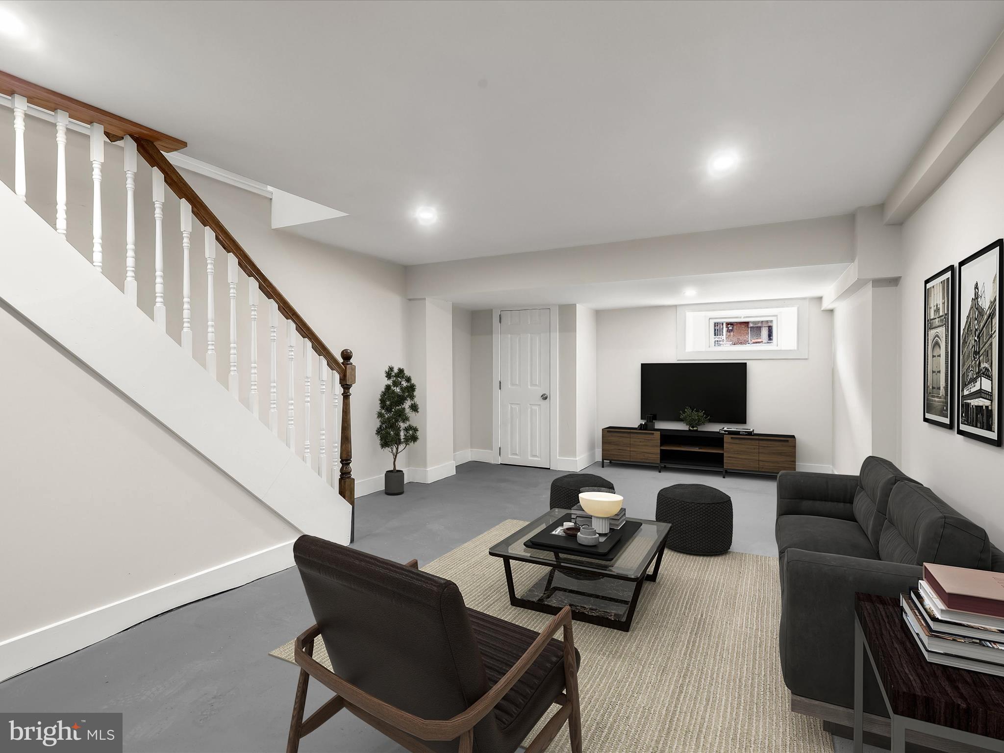 2800 East Chase Street Baltimore, MD 21213 - Photo 25 of 37 a living room with furniture a flat screen tv and a window