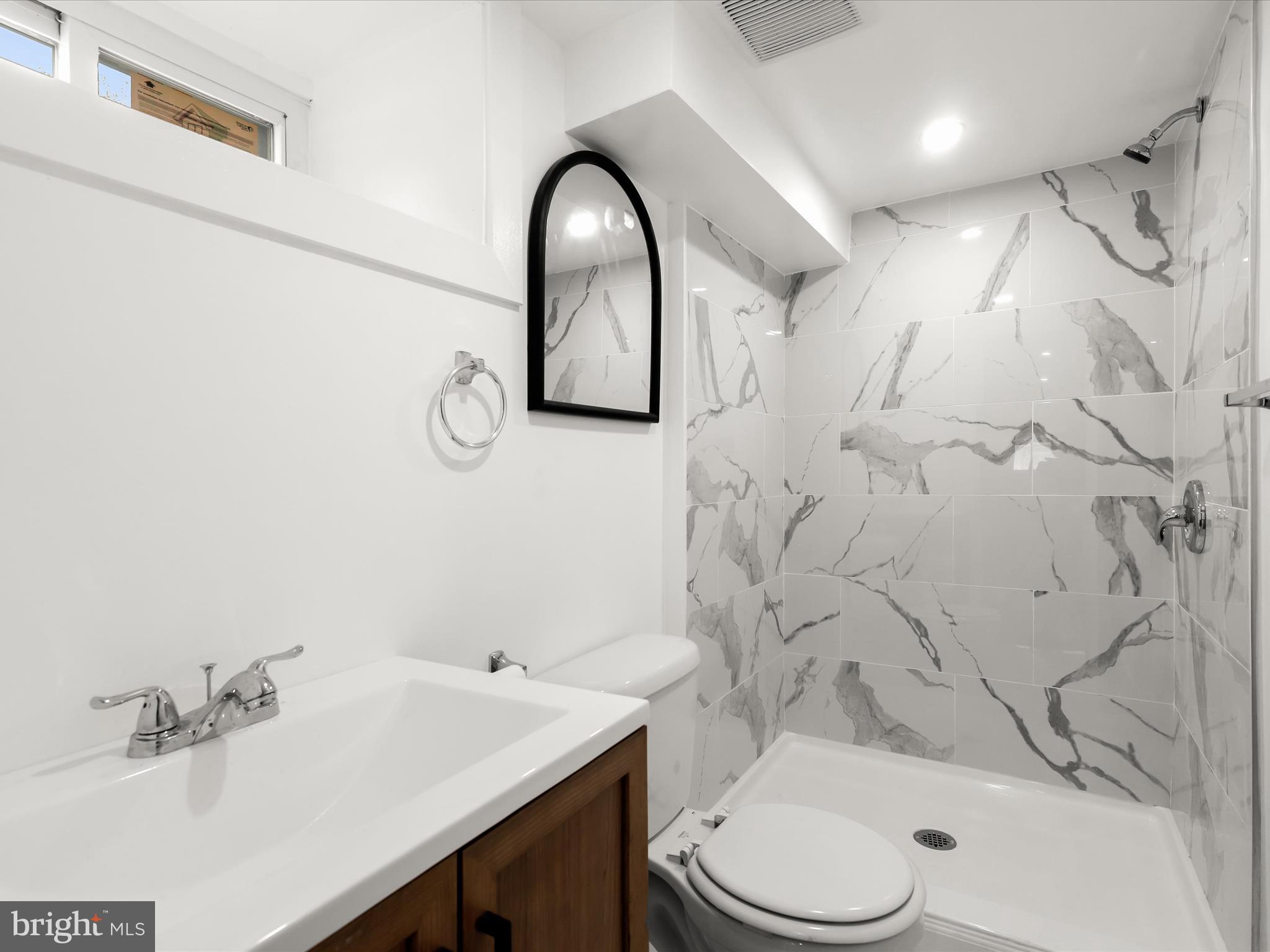 2800 East Chase Street Baltimore, MD 21213 - Photo 28 of 37 a bathroom with a sink toilet and shower