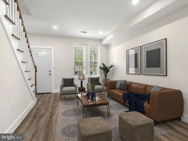 a living room with furniture and a painting