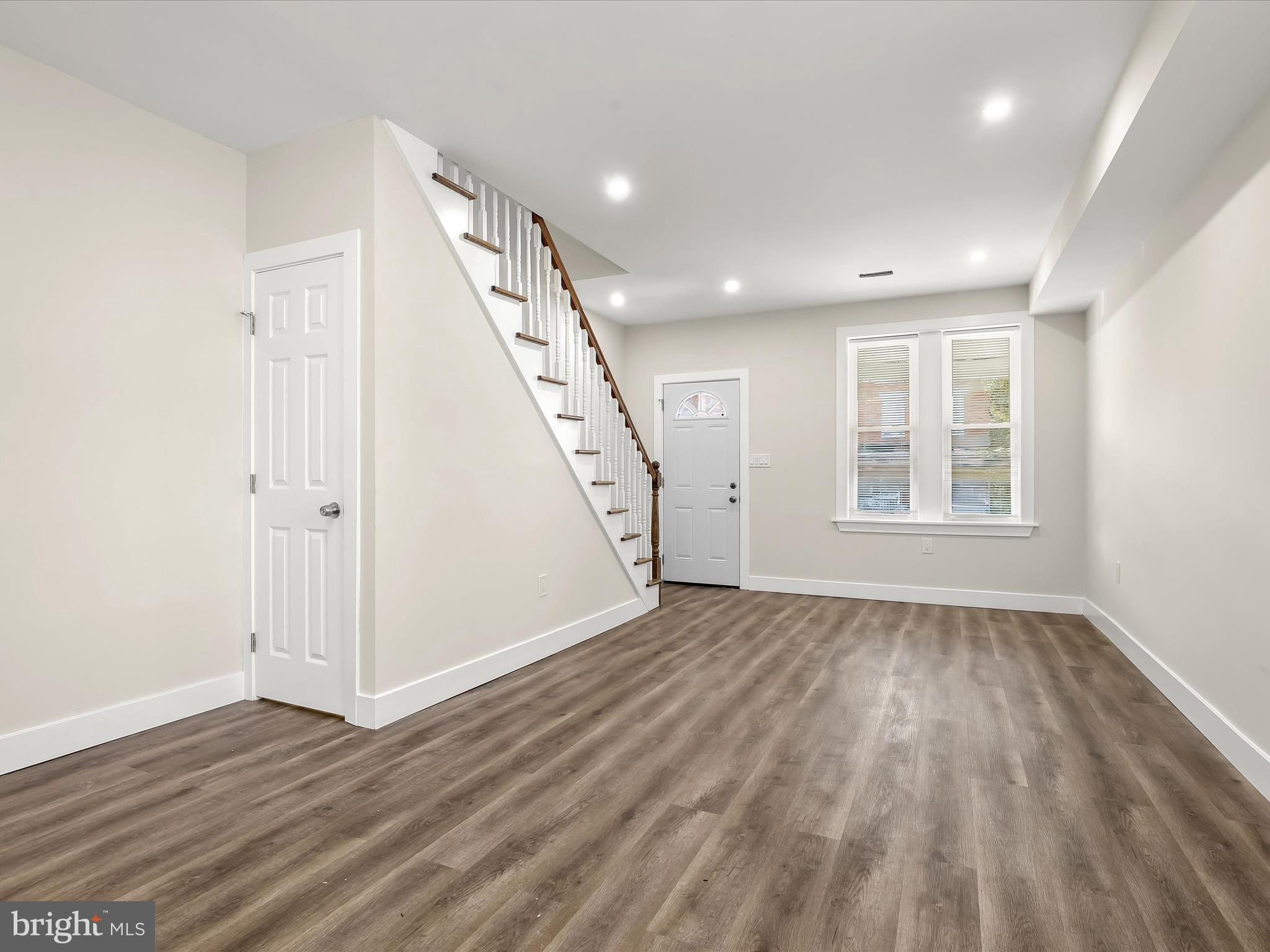 2800 East Chase Street Baltimore, MD 21213 - Photo 5 of 37 an empty room with wooden floor and windows