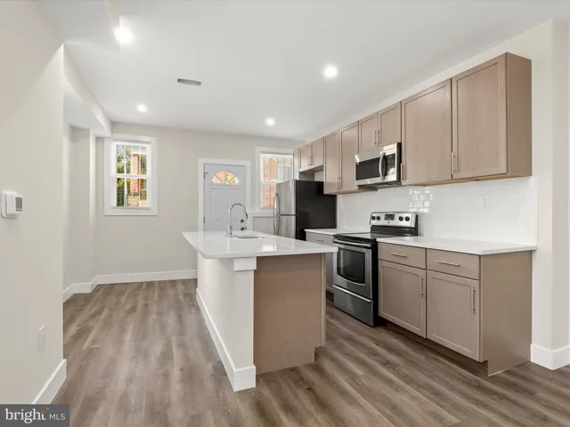 a kitchen with a sink window and cabinets