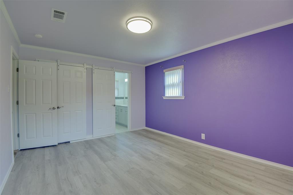 802 Cardinal Road Mansfield, TX 76063 - Photo 21 of 31 Unfurnished bedroom featuring crown molding, wood finished floors, connected bathroom, and a closet