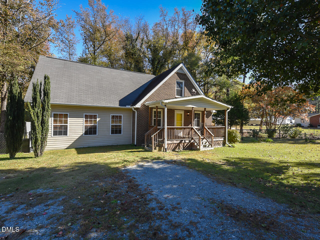 a front view of a house with swimming pool and yard
