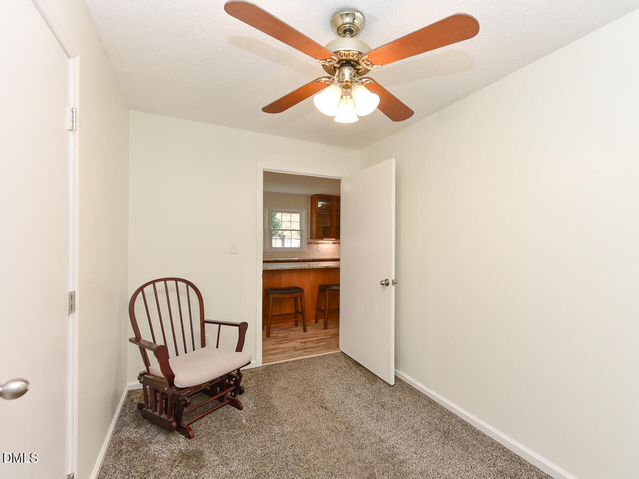 178 Paceville Road Selma, NC 27576 - Photo 21 of 30 a view of a hallway with a chair and a ceiling fan