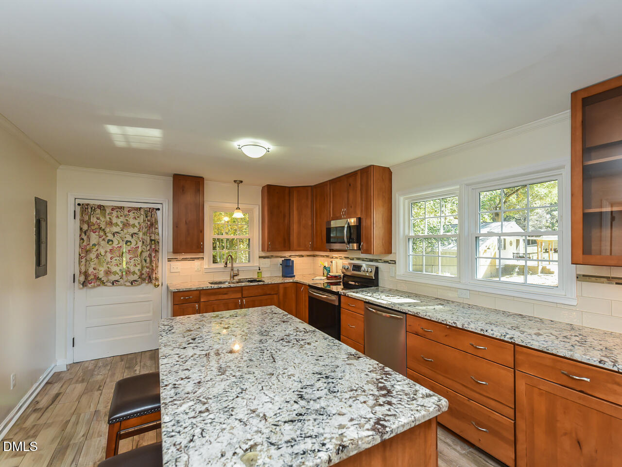 178 Paceville Road Selma, NC 27576 - Photo 9 of 30 a large kitchen with kitchen island a sink stove and wooden cabinets