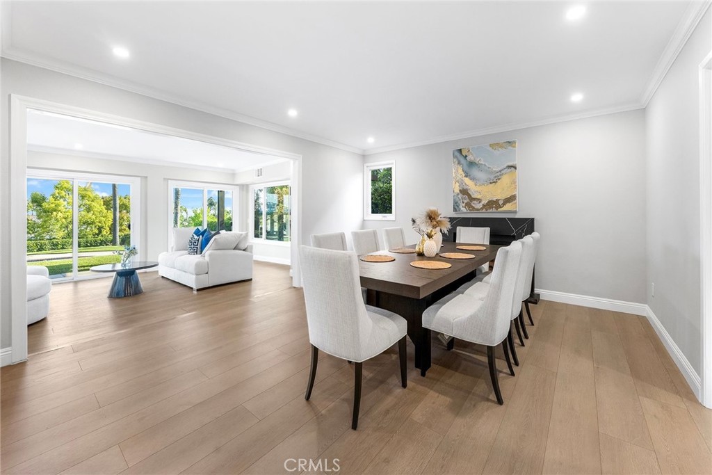 8093 Banyan Street Rancho Cucamonga, CA 91701 - Photo 17 of 65 a view of a dining room with furniture a chandelier and wooden floor