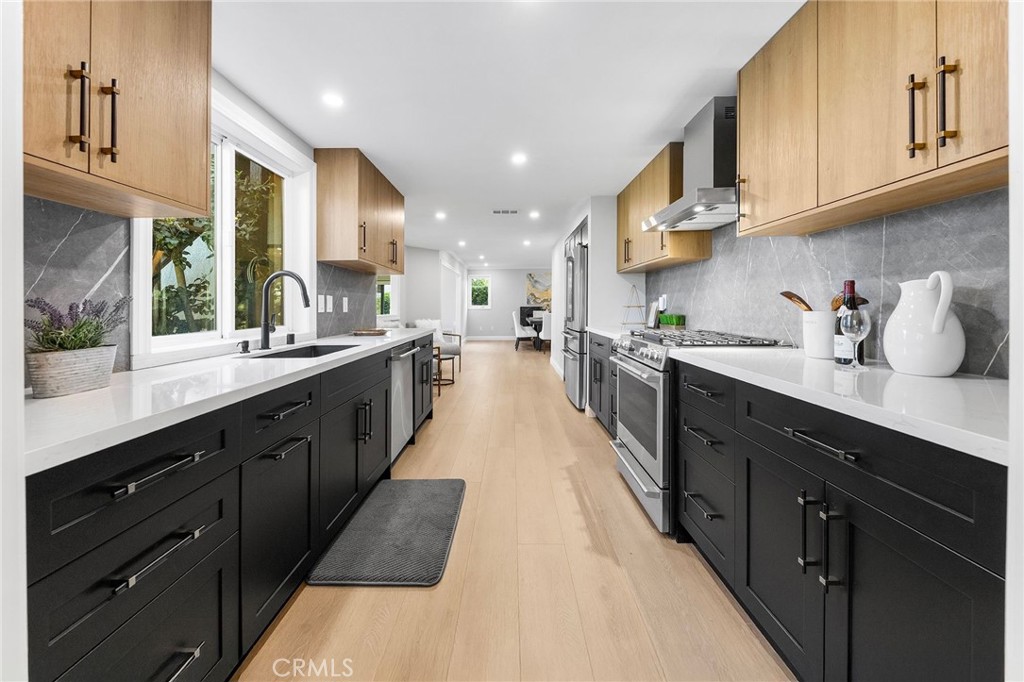 8093 Banyan Street Rancho Cucamonga, CA 91701 - Photo 18 of 65 a large kitchen with stainless steel appliances lots of counter space and a sink