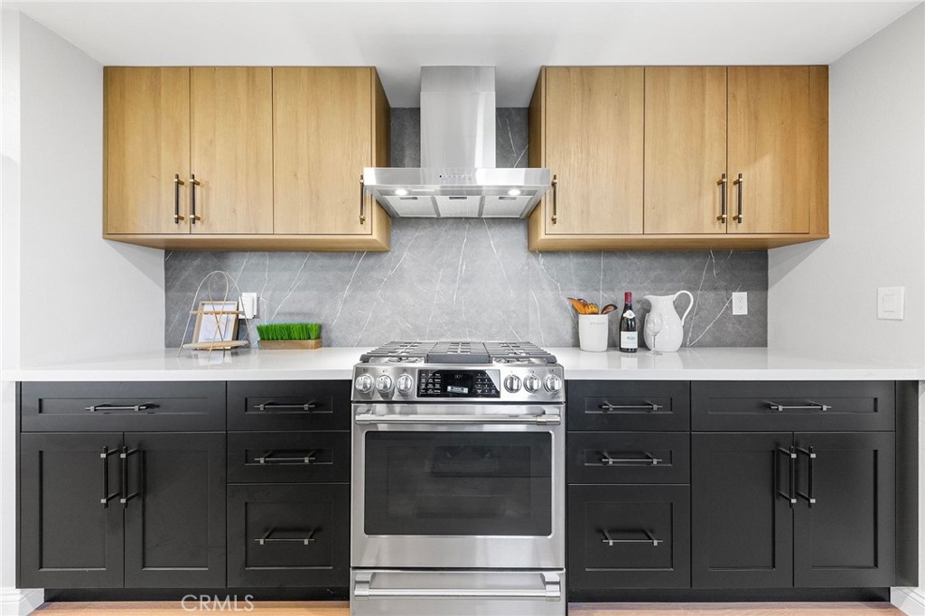 8093 Banyan Street Rancho Cucamonga, CA 91701 - Photo 19 of 65 a kitchen with stainless steel appliances granite countertop a stove a sink and cabinets