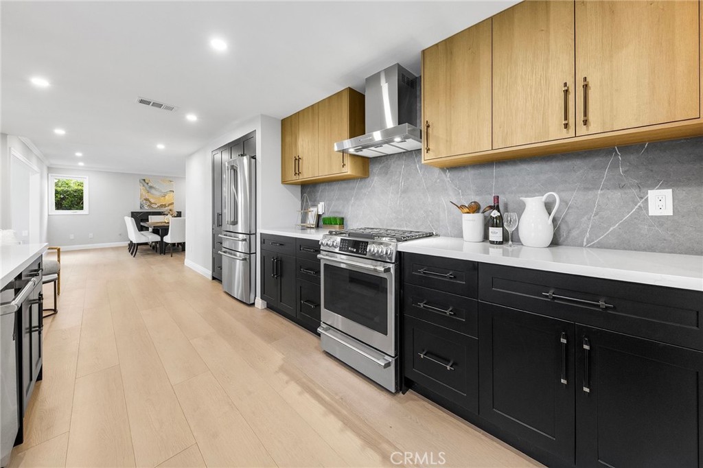 8093 Banyan Street Rancho Cucamonga, CA 91701 - Photo 20 of 65 a kitchen with stainless steel appliances granite countertop a sink stove and cabinets