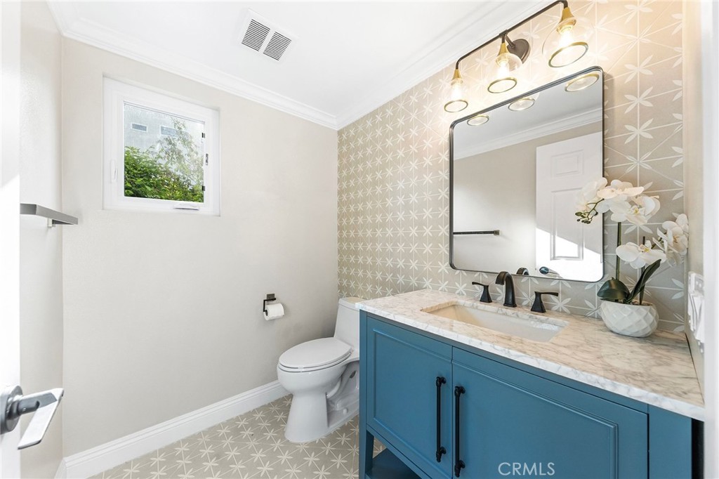 8093 Banyan Street Rancho Cucamonga, CA 91701 - Photo 27 of 65 a bathroom with a toilet sink and mirror