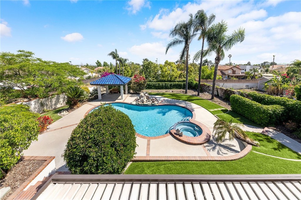 8093 Banyan Street Rancho Cucamonga, CA 91701 - Photo 43 of 65 a view of a swimming pool with a garden and plants