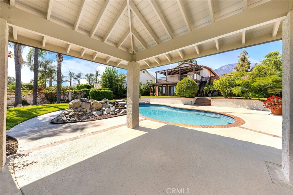 8093 Banyan Street Rancho Cucamonga, CA 91701 - Photo 52 of 65 a view of a patio with a table and chairs under an umbrella