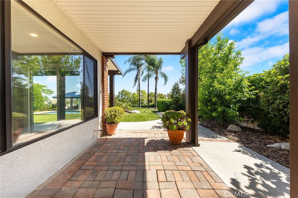 8093 Banyan Street Rancho Cucamonga, CA 91701 - Photo 56 of 65 a view of a patio with table and chairs potted plants with floor to ceiling window