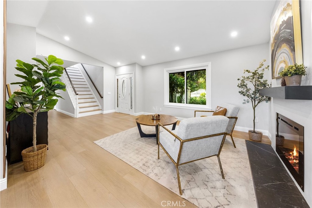 8093 Banyan Street Rancho Cucamonga, CA 91701 - Photo 6 of 65 a living room with furniture a potted plant and a fireplace