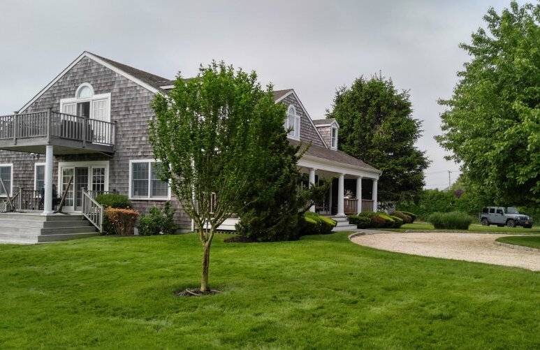 491 Butter Lane Bridgehampton, NY 11932 - Photo 30 of 39 a front view of a house with a yard and tree