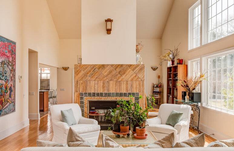491 Butter Lane Bridgehampton, NY 11932 - Photo 9 of 39 a living room with furniture a fireplace and a large window