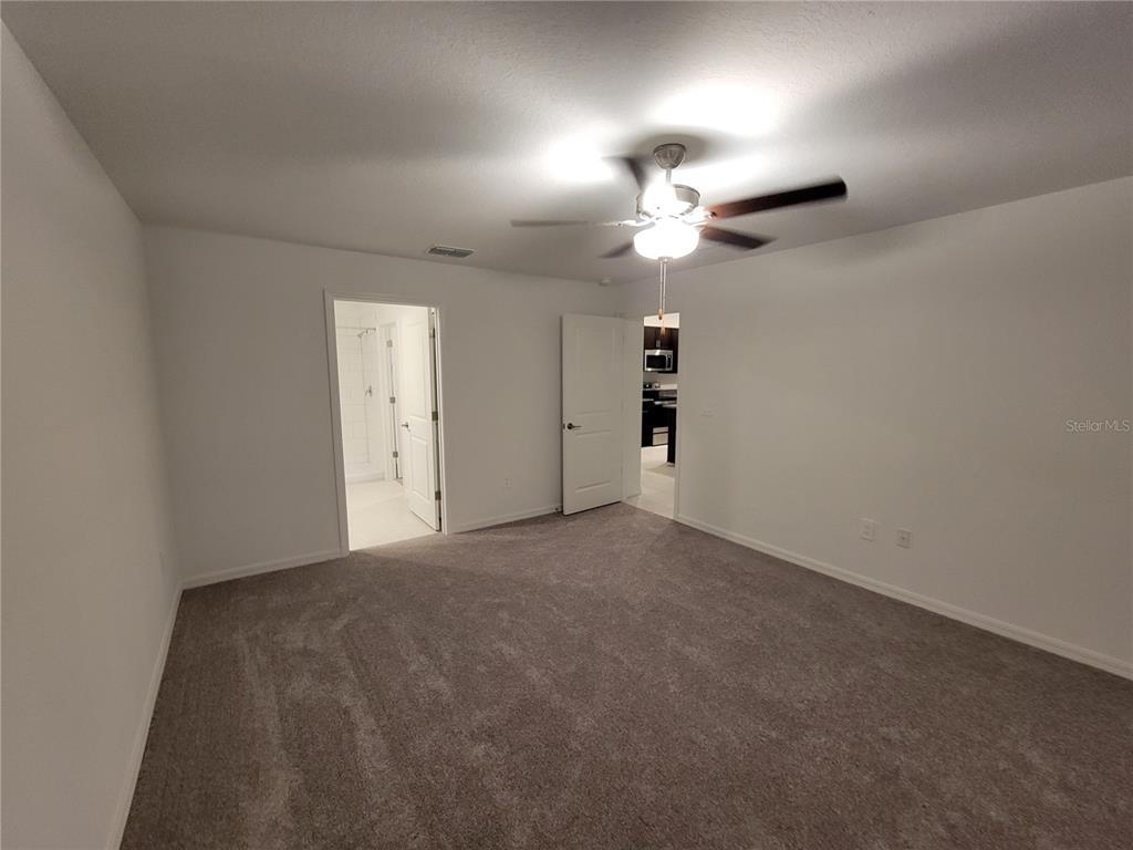 1844 Red Loop Lakeland, FL 33801 - Photo 17 of 24 en empty room with windows and fan