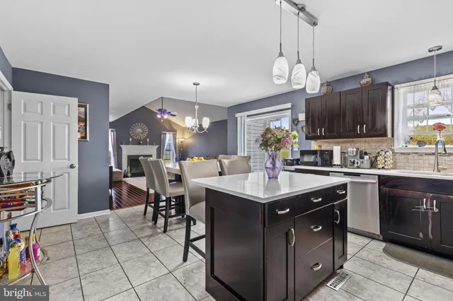 a kitchen with a sink counter top space appliances and cabinets