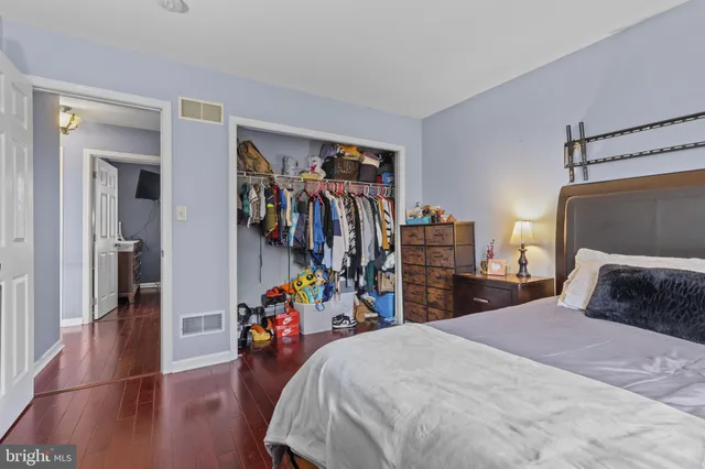 a bedroom with a bed and a view of walk in closet