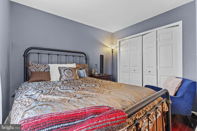 a bedroom with a large bed and a dresser