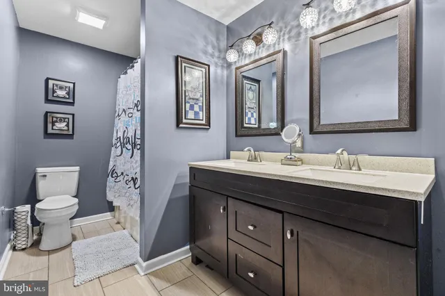 a bathroom with a double vanity sink and a mirror