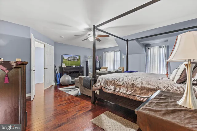 a bed sitting in a spacious bedroom next to a window