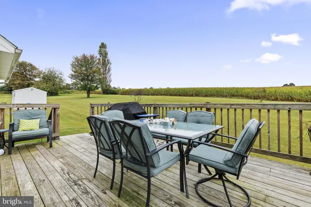 a view of a chairs and table on the deck