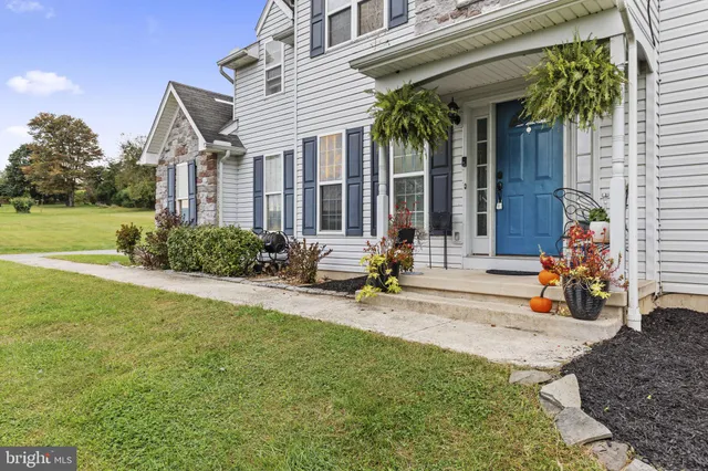 a view of a house with backyard porch and sitting area