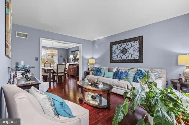 a living room with furniture and flowers