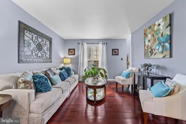 a living room with furniture kitchen and window