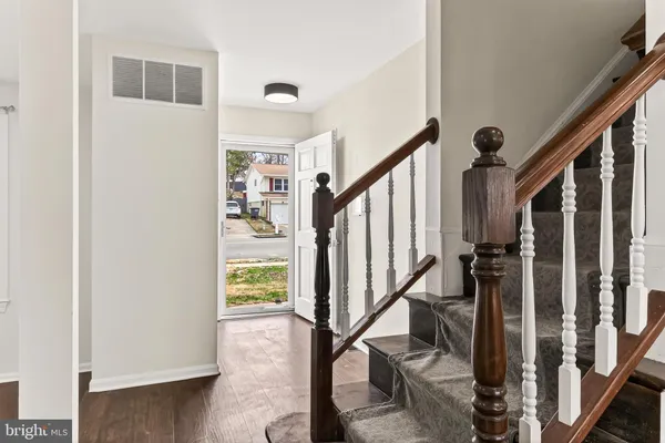 a bathroom with a toilet mirror and vanity