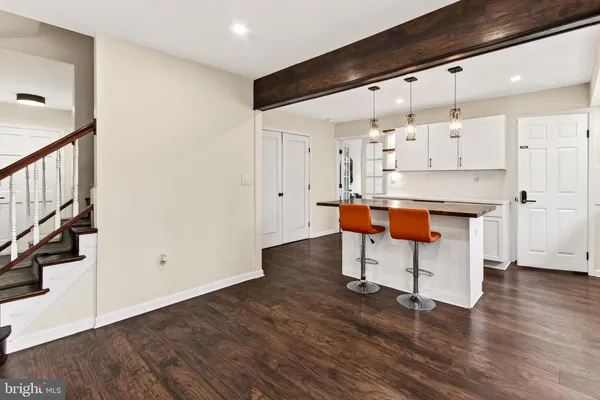 a kitchen with stainless steel appliances granite countertop a sink a stove a counter space and cabinets