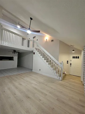 a view of an empty room with a fireplace and a window