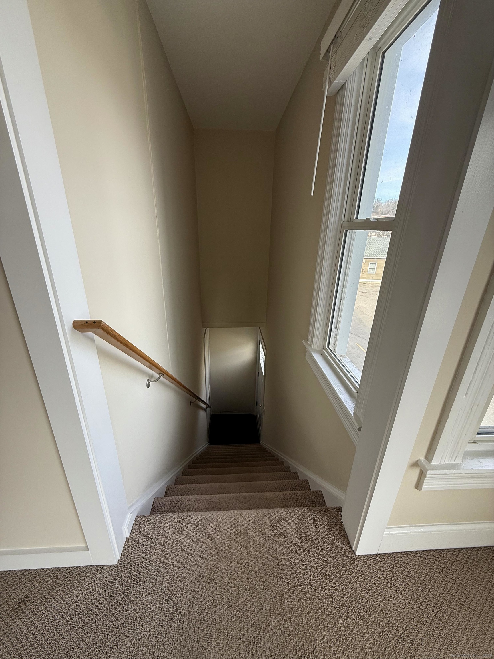 25 A Bridge Street, Unit 3 New Milford, CT 06776 - Photo 2 of 15 a view of an empty room with wooden floor and a window