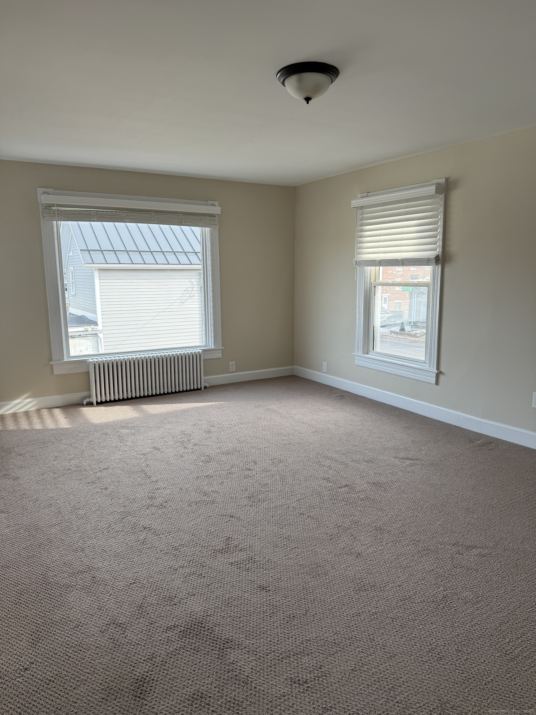 25 A Bridge Street, Unit 3 New Milford, CT 06776 - Photo 3 of 15 an empty room with a empty space and windows