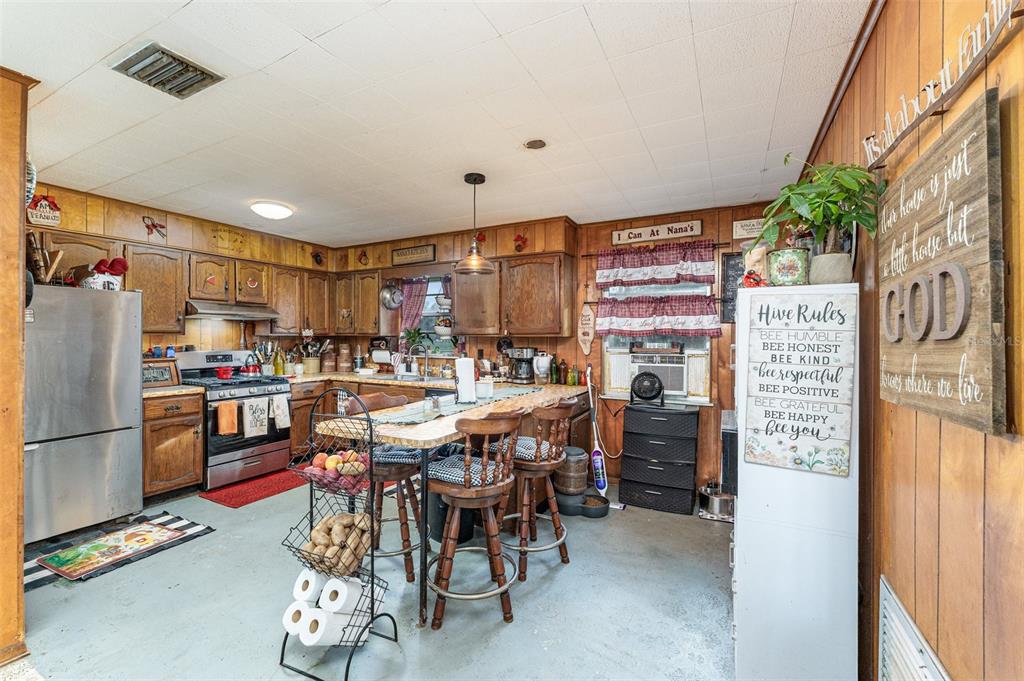 910 Bumby Lane Wauchula, FL 33873 - Photo 11 of 37 a kitchen with stainless steel appliances kitchen island granite countertop a refrigerator and a stove top oven