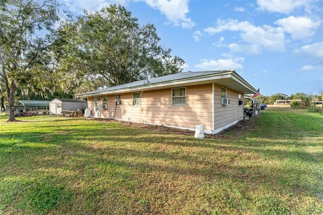 a front view of house with yard and trees