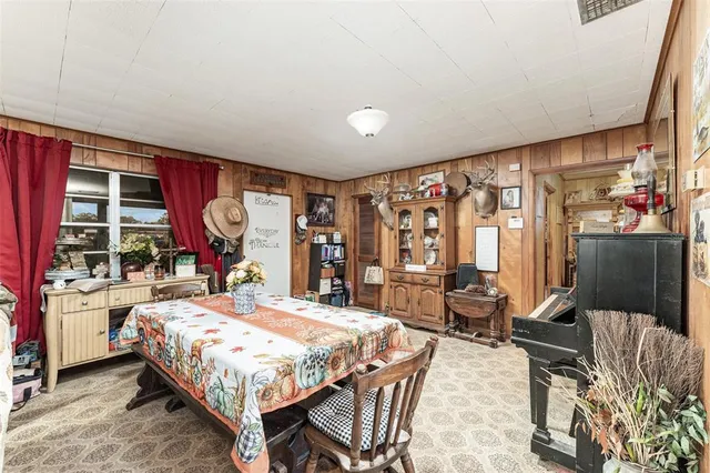 a bedroom with a bed a table and chair