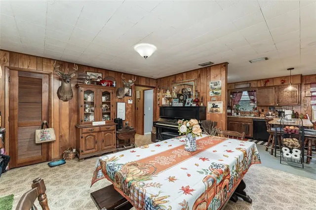 a bedroom with a bed and dresser with chair