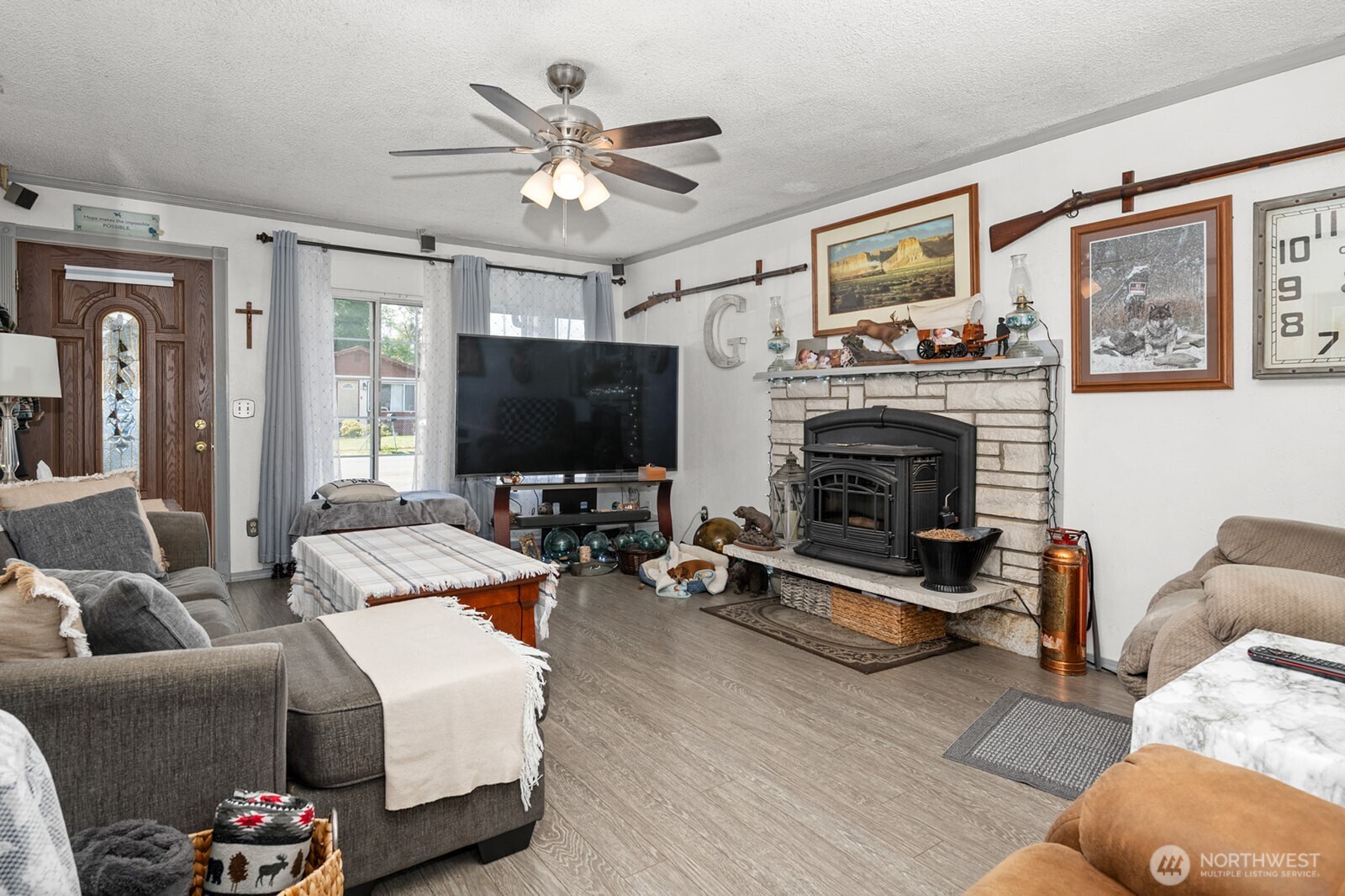 700 Harding Road Aberdeen, WA 98520 - Photo 5 of 21 a living room with furniture a flat screen tv and a fireplace
