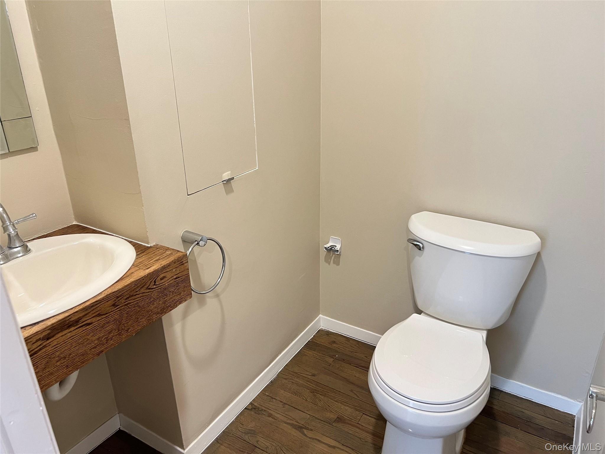 60 Marwood Road North, Unit B / RIGHT Port Washington, NY 11050 - Photo 4 of 19 a bathroom with a granite countertop toilet and a sink