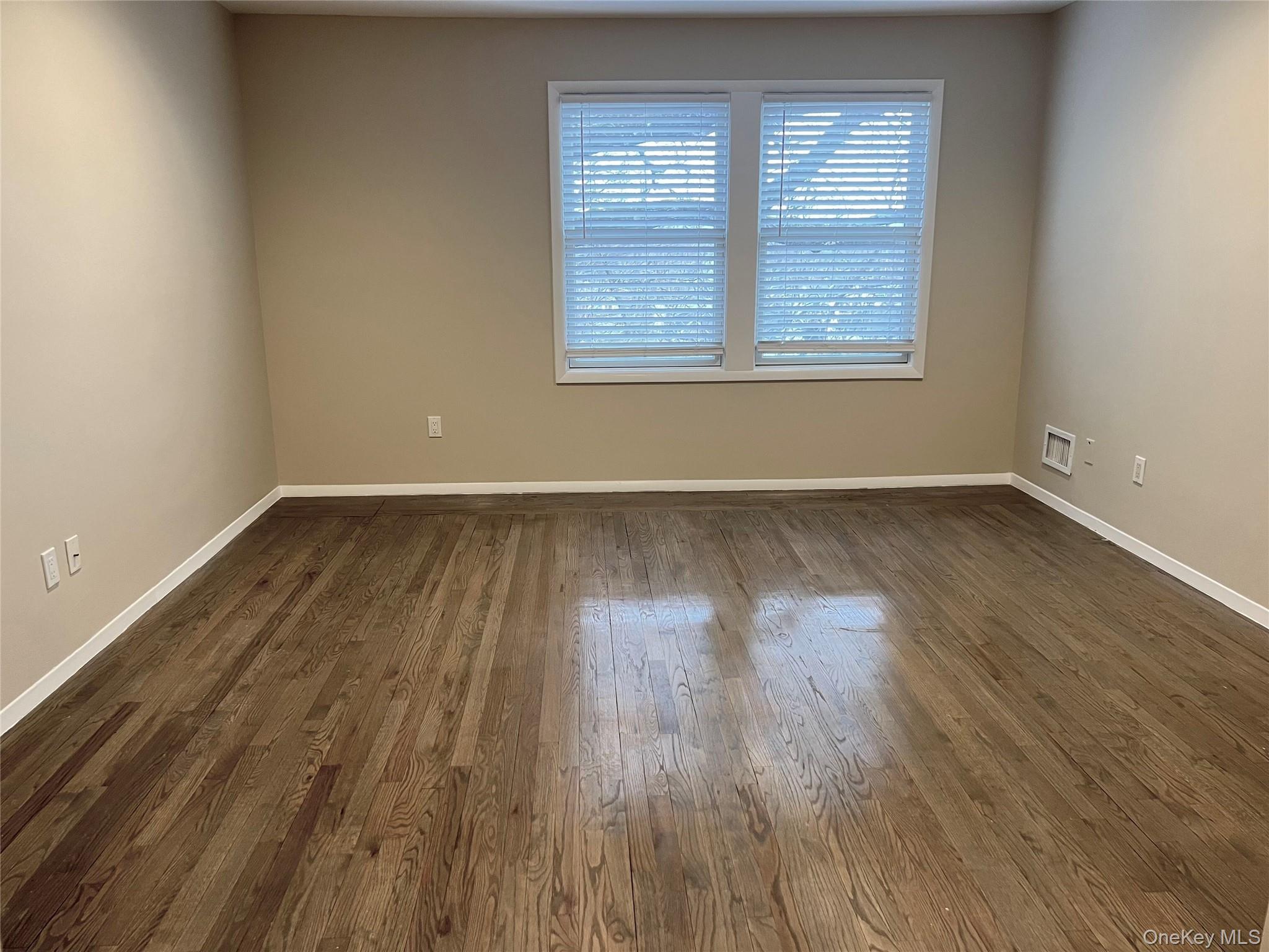 60 Marwood Road North, Unit B / RIGHT Port Washington, NY 11050 - Photo 6 of 19 an empty room with wooden floor and windows