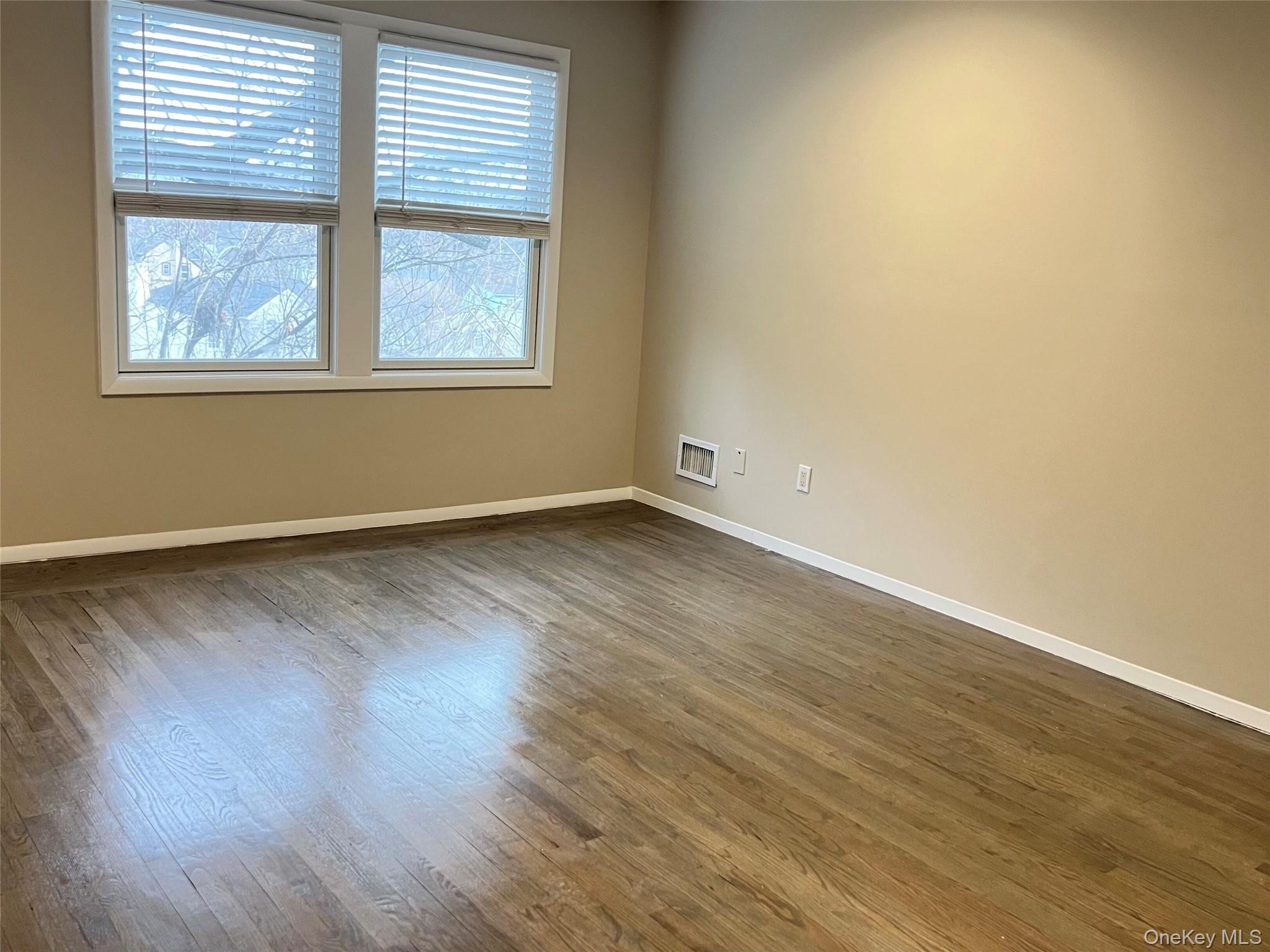 60 Marwood Road North, Unit B / RIGHT Port Washington, NY 11050 - Photo 8 of 19 an empty room with wooden floor and windows