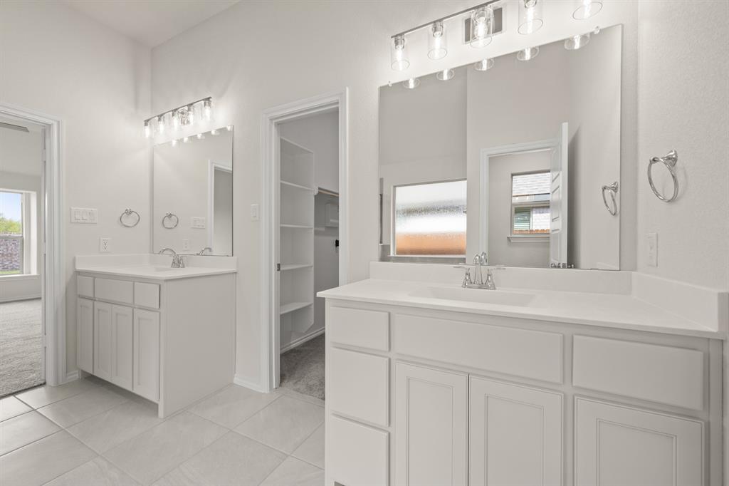10809 Rothland Street Crowley, TX 76036 - Photo 10 of 30 a bathroom with a sink vanity and mirror