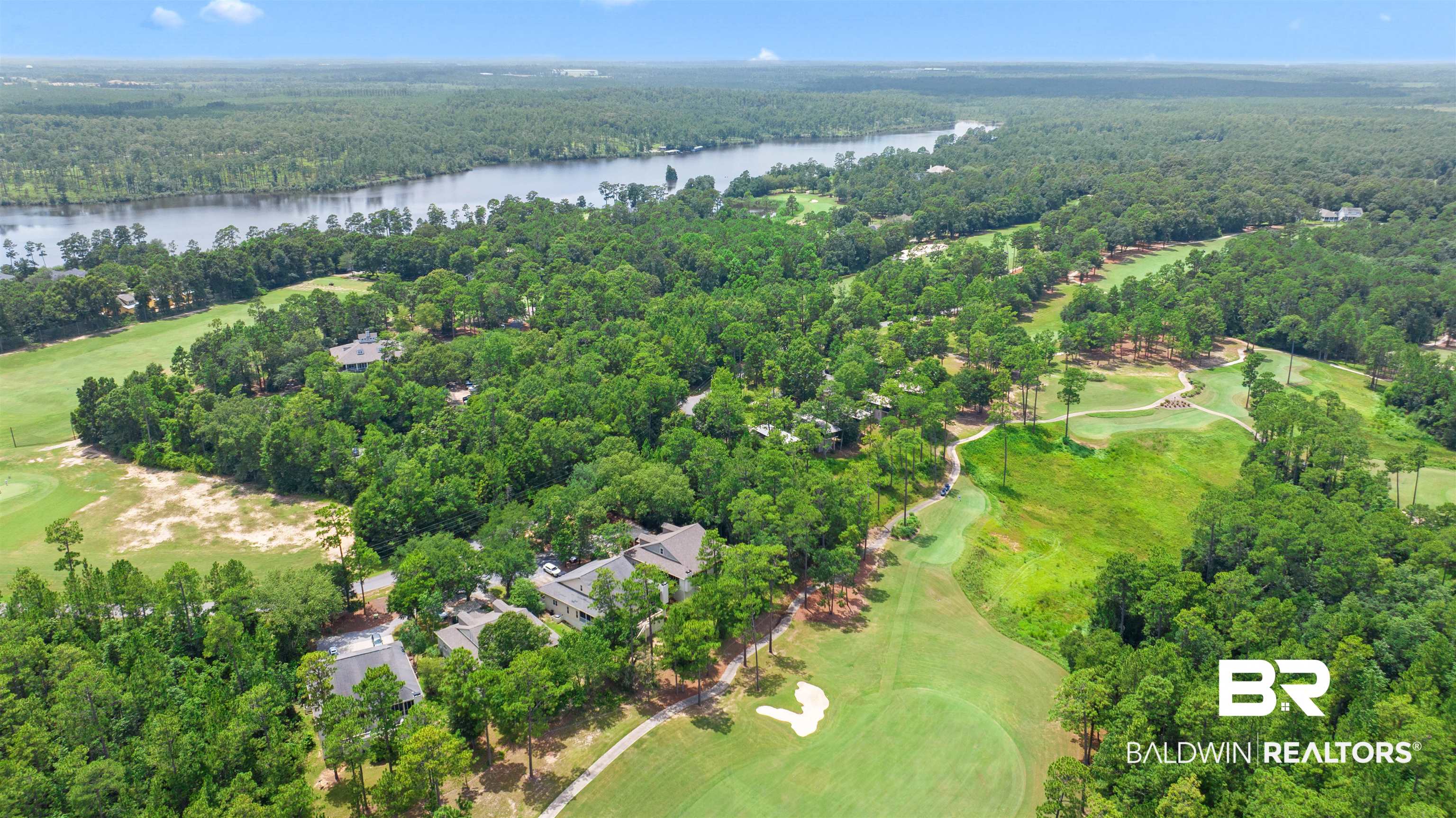 32700 Steelwood Ridge Road, Unit D Loxley, AL 36551 - Photo 38 of 41 Aerial perspective showcasing expansive golf course frontage, mature tree canopy, and tranquil river bordering the property