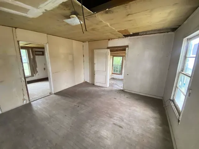 a view of a big room with windows and chandelier
