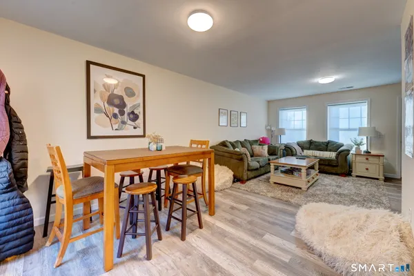 a living room with furniture a rug and a window