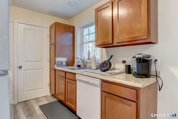 a kitchen with stainless steel appliances granite countertop a sink stove and cabinets