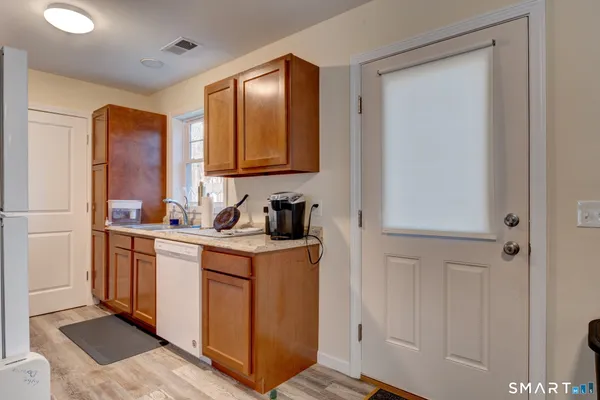 a kitchen with stainless steel appliances granite countertop a refrigerator and sink